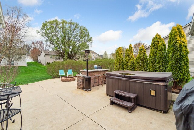 view of patio with a hot tub and a fire pit