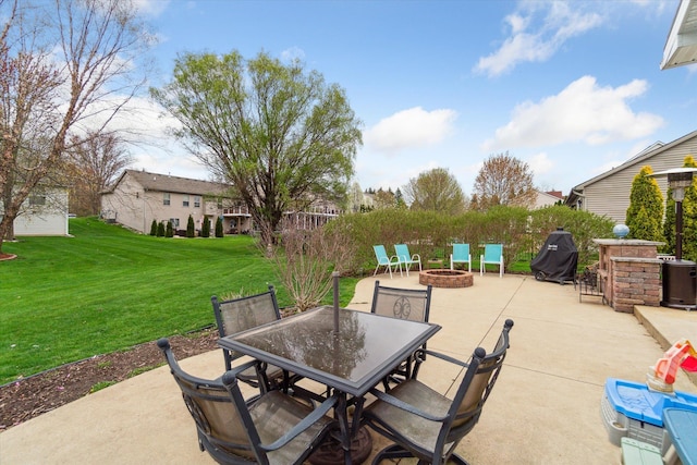 view of patio / terrace with grilling area, outdoor dining area, and an outdoor fire pit