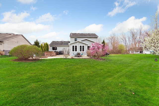 rear view of property featuring a yard and a patio