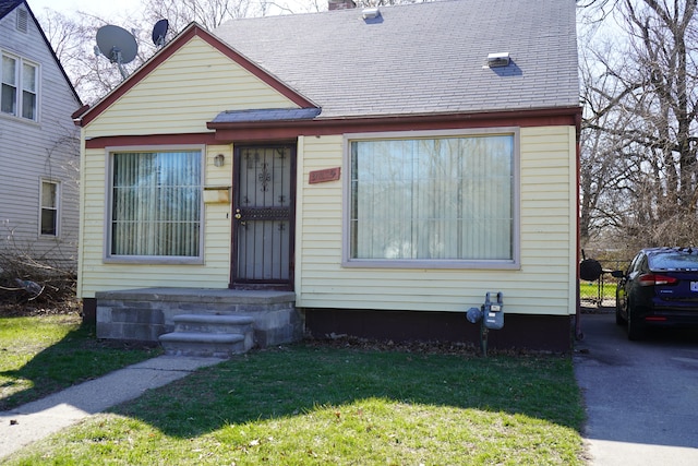 20115 Santa Barbara Dr, Detroit, MI 48221 - bungalow-style house with roof with shingles, a chimney, and a front lawn