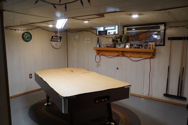 20115 Santa Barbara Dr, Detroit, MI 48221 - game room featuring a paneled ceiling, finished concrete floors, and wooden walls