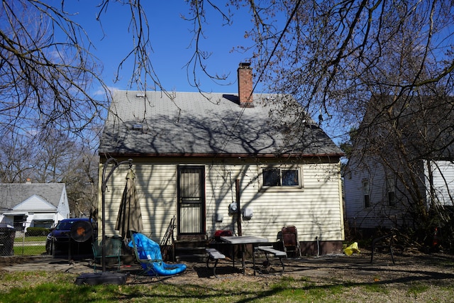 20115 Santa Barbara Dr, Detroit, MI 48221 - rear view of house featuring entry steps, fence, and a chimney