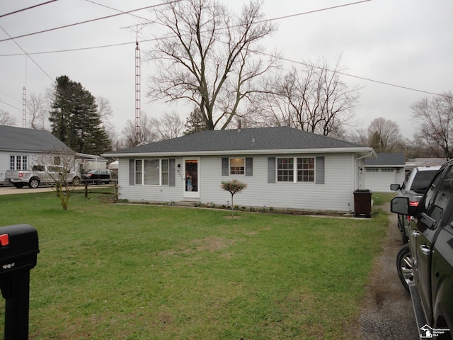 single story home with a front lawn, entry steps, and a garage