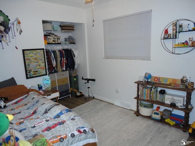 bedroom featuring visible vents, wood finished floors, and a closet