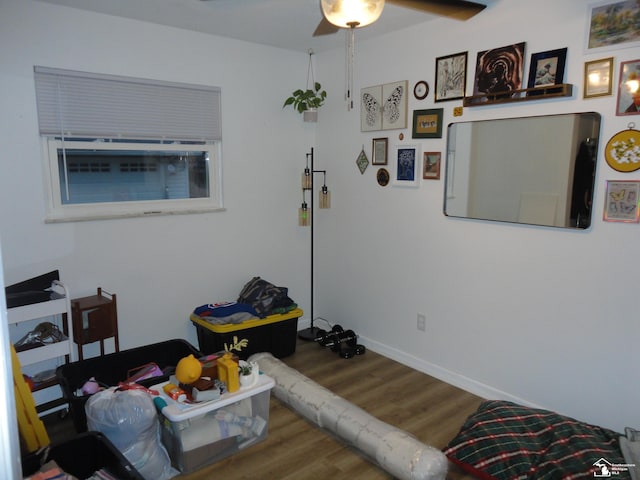 interior space with baseboards and wood finished floors