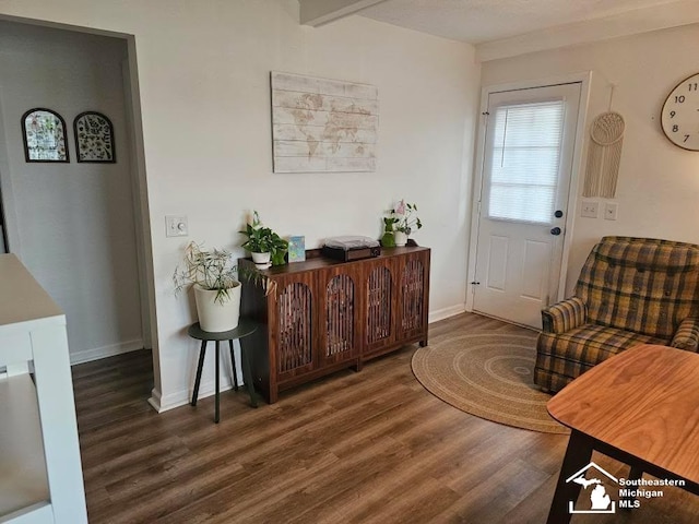 doorway to outside with baseboards and wood finished floors