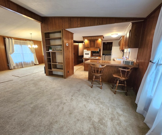interior space featuring wooden walls, a chandelier, and light carpet