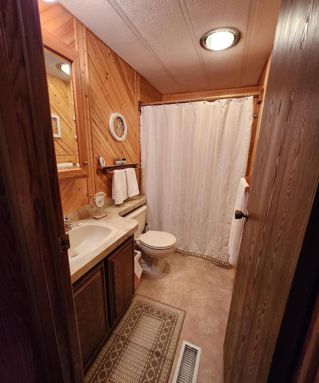 bathroom featuring vanity, a shower with curtain, toilet, wood walls, and visible vents