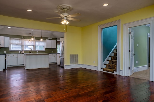 33 N Church St, Ortonville, MI 48462 - unfurnished living room featuring dark wood finished floors, stairway, ceiling fan, a sink, and visible vents