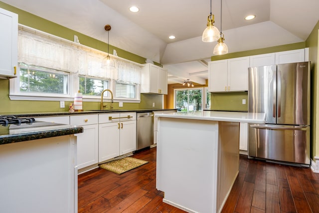 33 N Church St, Ortonville, MI 48462 - kitchen featuring a sink, white cabinets, appliances with stainless steel finishes, and lofted ceiling
