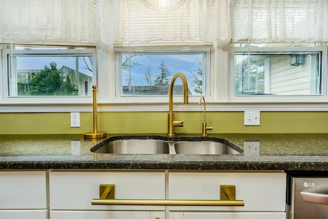 33 N Church St, Ortonville, MI 48462 - interior details featuring dark stone countertops, dishwasher, and a sink