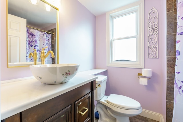 33 N Church St, Ortonville, MI 48462 - bathroom featuring toilet, curtained shower, vanity, and baseboards
