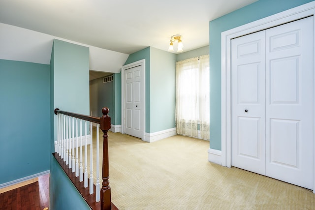 33 N Church St, Ortonville, MI 48462 - corridor with carpet, vaulted ceiling, an upstairs landing, baseboards, and visible vents