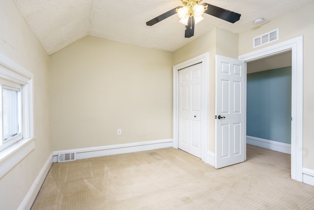 33 N Church St, Ortonville, MI 48462 - unfurnished bedroom featuring visible vents, a textured ceiling, a closet, and carpet flooring