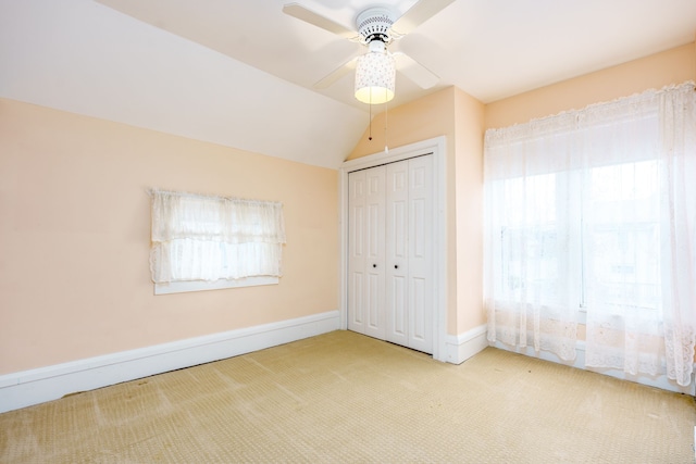 33 N Church St, Ortonville, MI 48462 - unfurnished bedroom with ceiling fan, baseboards, a closet, vaulted ceiling, and carpet