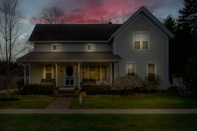 33 N Church St, Ortonville, MI 48462 - traditional-style home featuring covered porch, fence, a shingled roof, and a front lawn