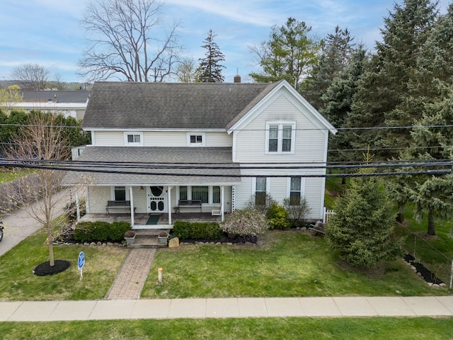 33 N Church St, Ortonville, MI 48462 - view of front of property with covered porch, a shingled roof, and a front yard