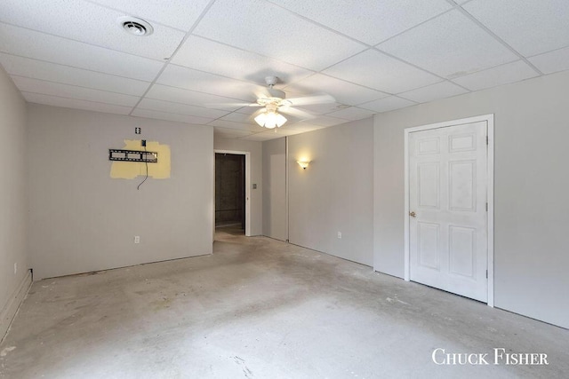 unfurnished room with visible vents, a ceiling fan, concrete flooring, and a drop ceiling
