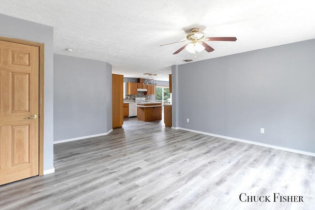 unfurnished living room with light wood finished floors, a ceiling fan, and baseboards