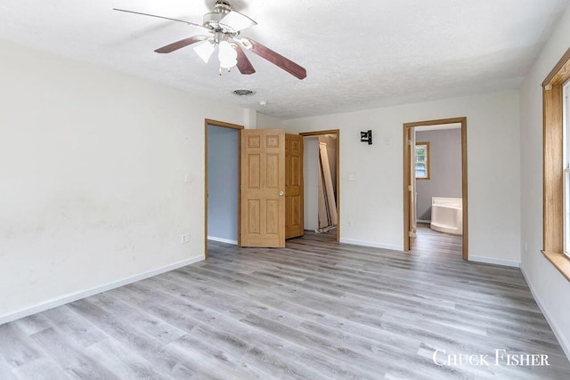 unfurnished bedroom with visible vents, light wood finished floors, baseboards, and a ceiling fan