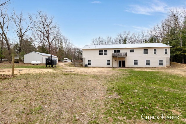 back of house featuring a yard and a deck