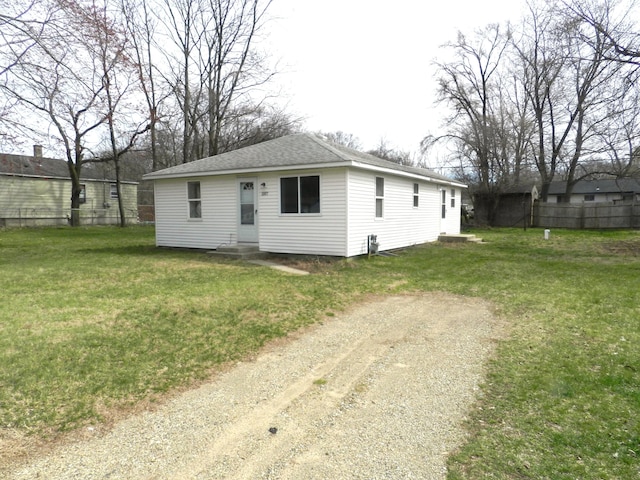 1187 Villa Ct, Benton Harbor, MI 49022 - view of front of house with entry steps, a shingled roof, and a front lawn