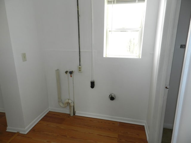 1187 Villa Ct, Benton Harbor, MI 49022 - laundry room featuring laundry area, wood finished floors, and baseboards