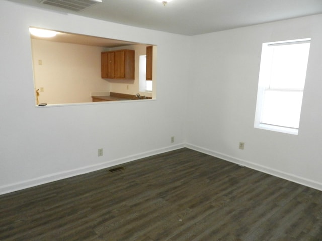 1187 Villa Ct, Benton Harbor, MI 49022 - unfurnished room with dark wood-type flooring, visible vents, and baseboards