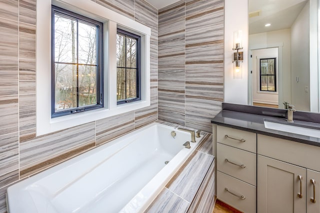 bathroom with a bath and vanity
