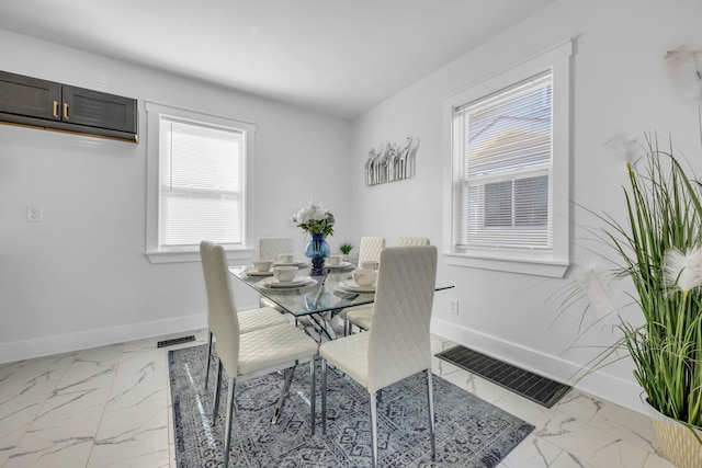 dining room with visible vents, marble finish floor, and baseboards