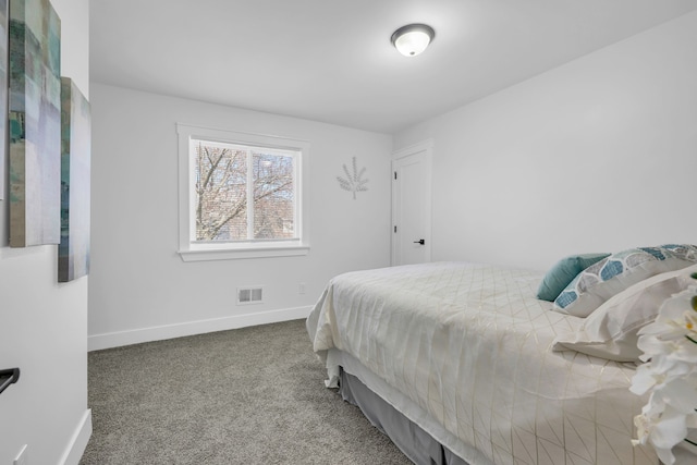 carpeted bedroom featuring visible vents and baseboards