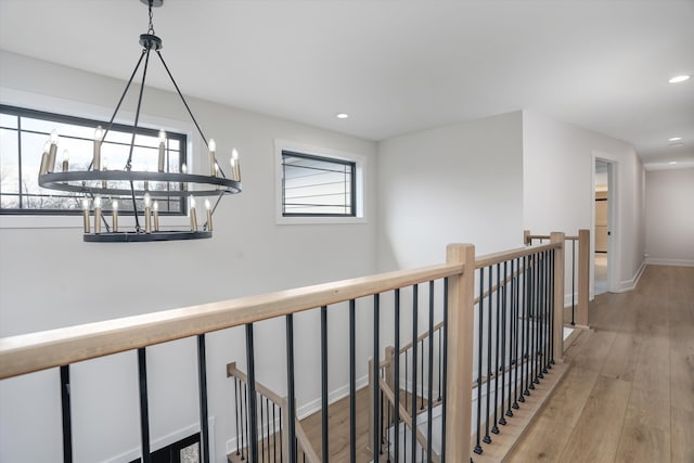 21907 Westcroft Dr, Grosse Ile, MI 48138 - hallway featuring wood finished floors, baseboards, an upstairs landing, and recessed lighting