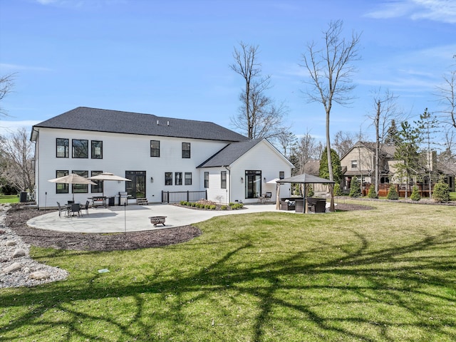 21907 Westcroft Dr, Grosse Ile, MI 48138 - back of house with a yard, a gazebo, a shingled roof, and a patio