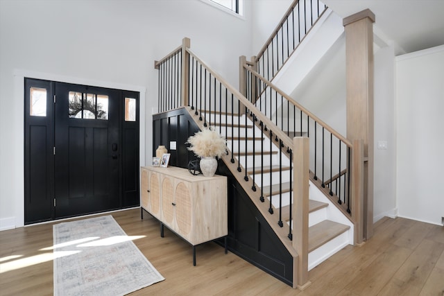 21907 Westcroft Dr, Grosse Ile, MI 48138 - entrance foyer featuring wood finished floors, a high ceiling, baseboards, and stairs