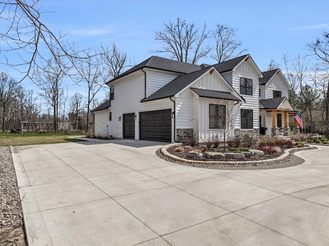21907 Westcroft Dr, Grosse Ile, MI 48138 - view of property exterior featuring a shingled roof, an attached garage, stone siding, board and batten siding, and driveway