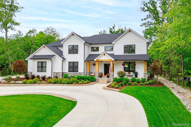 21907 Westcroft Dr, Grosse Ile, MI 48138 - modern farmhouse style home with board and batten siding, a porch, curved driveway, and a front yard