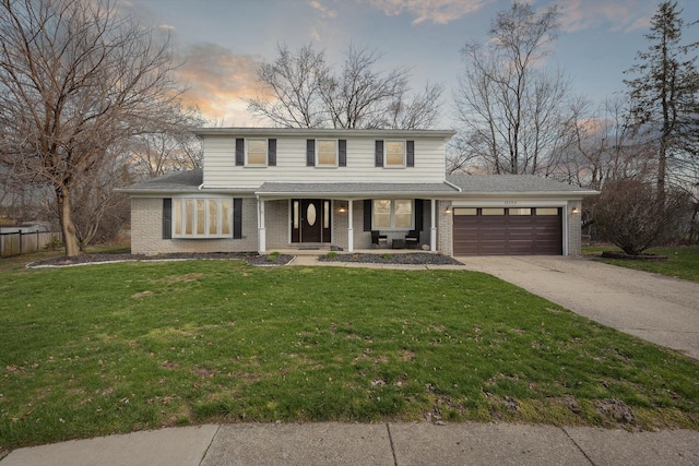 traditional-style home with concrete driveway, a front yard, brick siding, and an attached garage