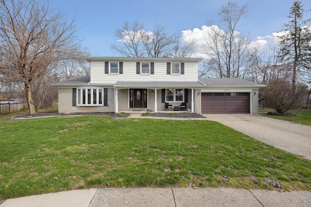 traditional-style house with a garage, brick siding, driveway, and a front lawn