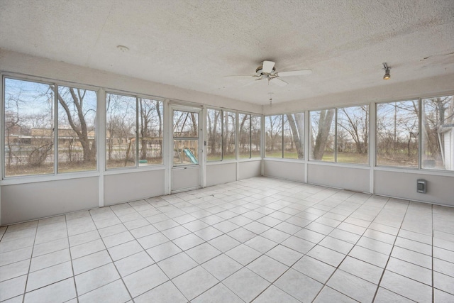 unfurnished sunroom with a ceiling fan