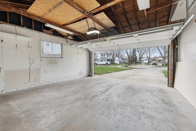 garage featuring a garage door opener and a residential view
