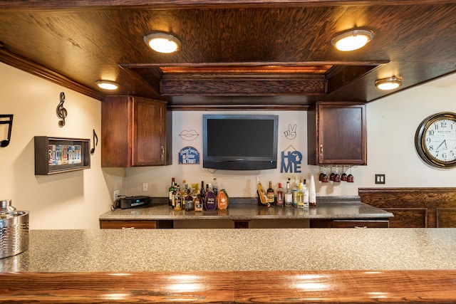 indoor dry bar with a tray ceiling, crown molding, and wood ceiling