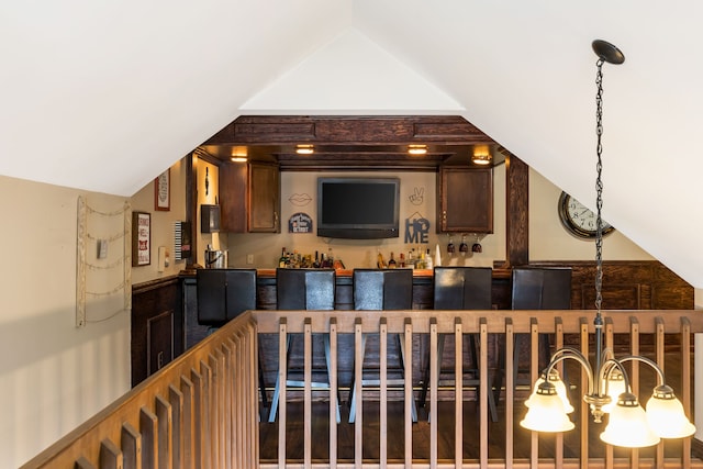indoor wet bar with vaulted ceiling