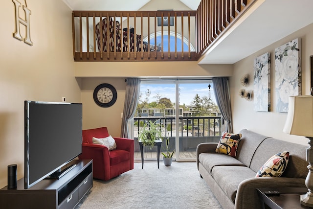 living room featuring carpet floors and a towering ceiling