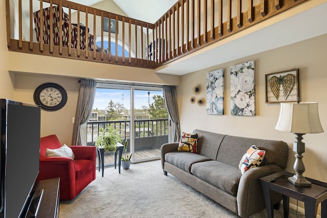 living room featuring carpet and high vaulted ceiling