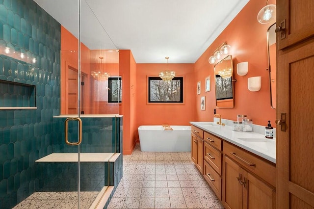 bathroom with a freestanding tub, baseboards, double vanity, a stall shower, and a sink