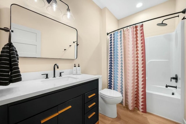 bathroom with toilet, shower / bath combo, wood finished floors, and vanity