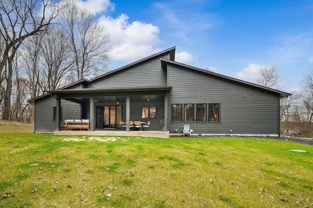 back of house featuring a patio and a lawn