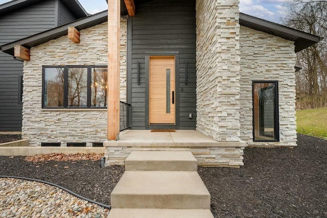 entrance to property featuring stone siding