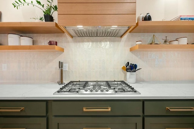 kitchen featuring tasteful backsplash, open shelves, stainless steel gas cooktop, and green cabinetry