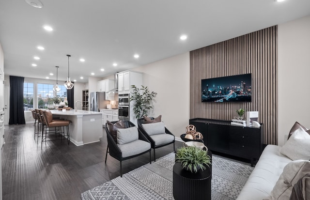 living room featuring baseboards, dark wood-style floors, and recessed lighting